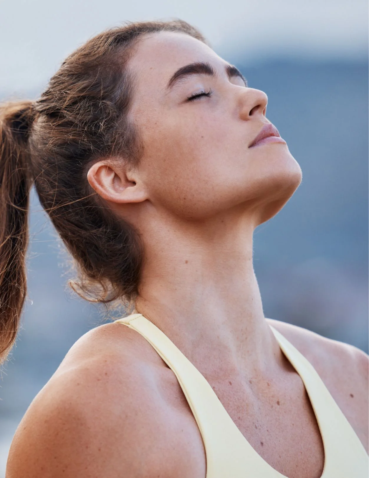 a young woman's profile, her head tipped back and her eyes closed