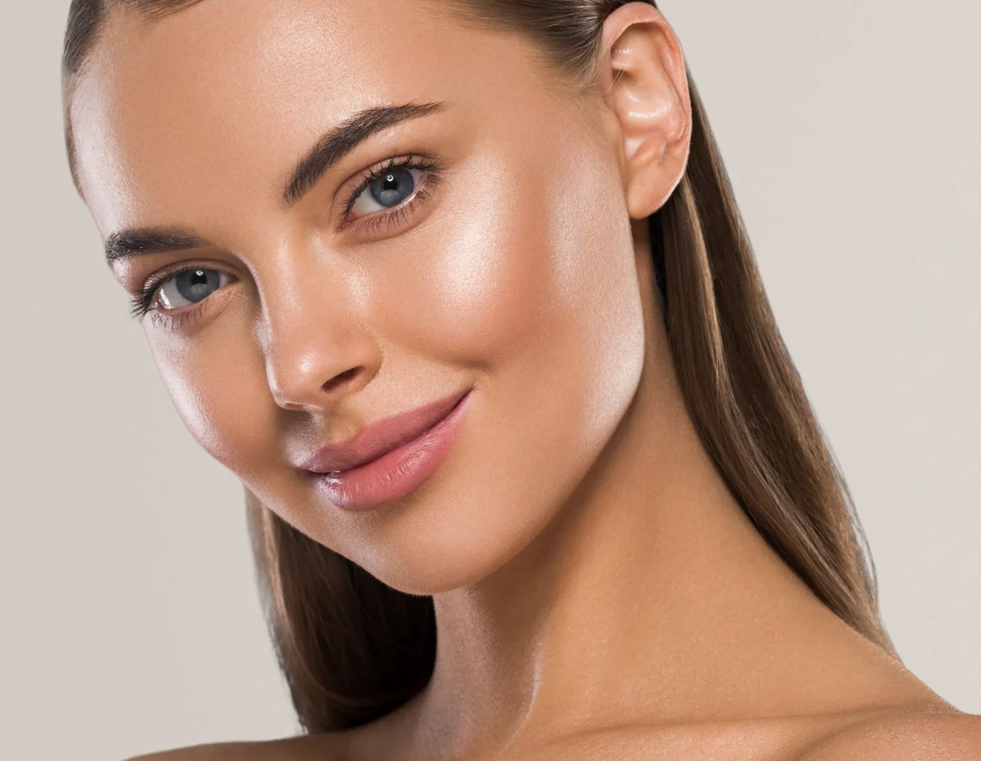 a closeup of a young woman with blue eyes and pink rosy lips