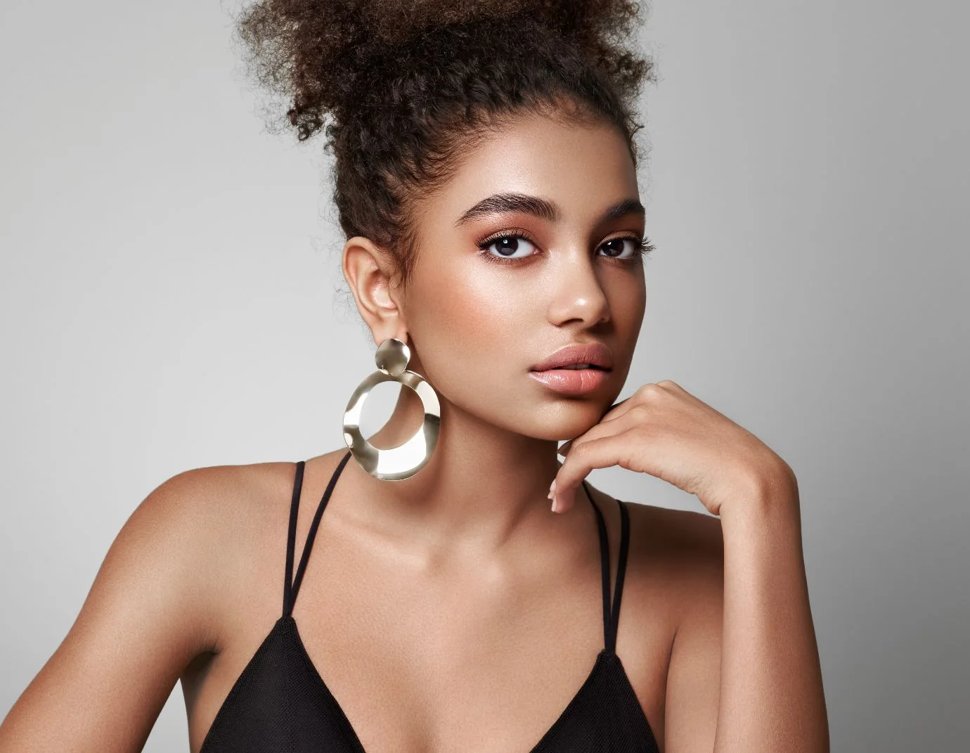 a close up shot of a black woman with her hand against her face