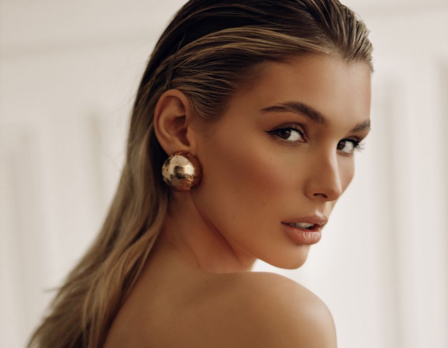 young blond woman with looking over her shoulder