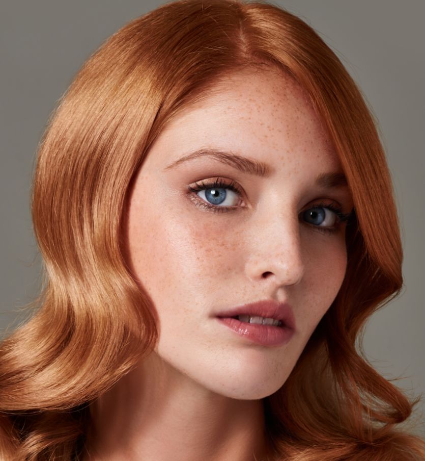 close up portrait of a red hair woman with blue eyes and